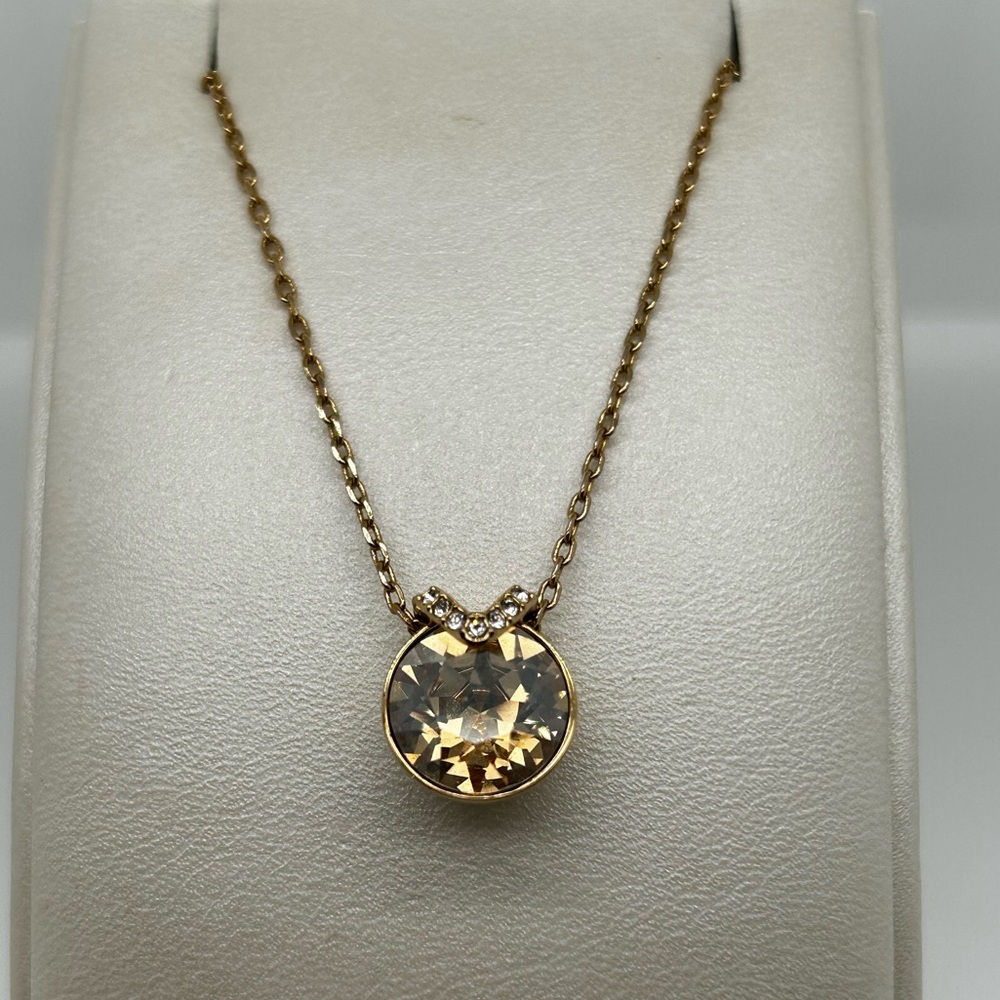 Swarovski crystal necklace. Gold plated. Crystal is a champagne color.